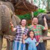 Family posing with elephants
