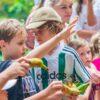 Children feeding bananas to an elephant