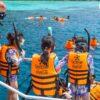 Snorkelers entering the water, Surin
